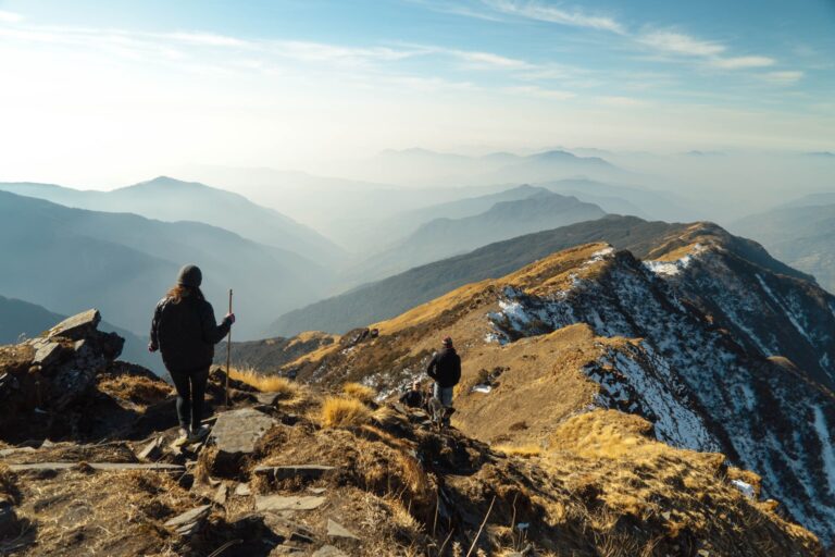 Wanderer mit Rucksack auf einem Bergkamm im Morgenlicht